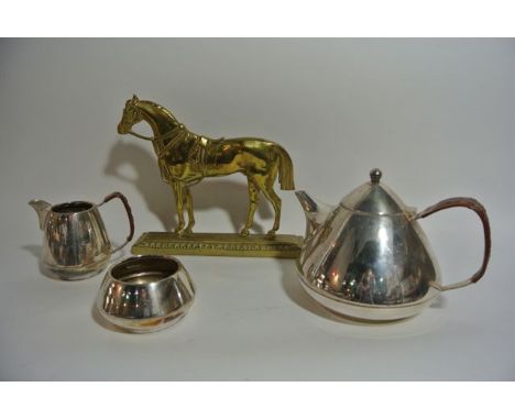 A three piece electroplated tea set by David Lawrence to include a cone shaped teapot with  hinged lid with leather clad fini