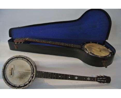A five string banjo with ebonised bridge with decoration in inlaid mother of pearl, stamped W Dennis 7744, the drum surround 