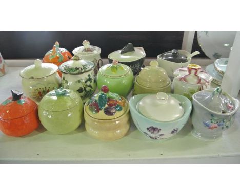 A collection of fourteen various jam, marmalade and other preserve pots and covers, various designs, with moulded and painted