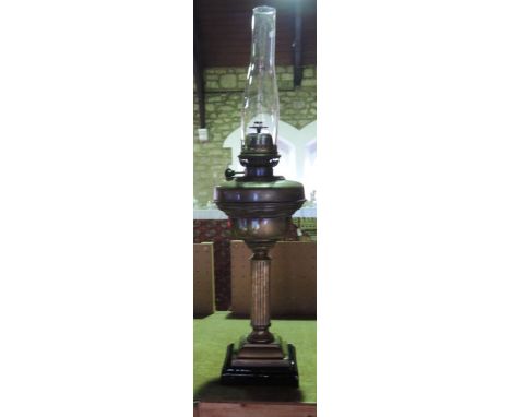 A Victorian brass column oil lamp with reeded column and single burner
