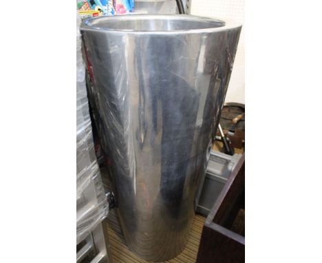A tall stainless steel garden planter