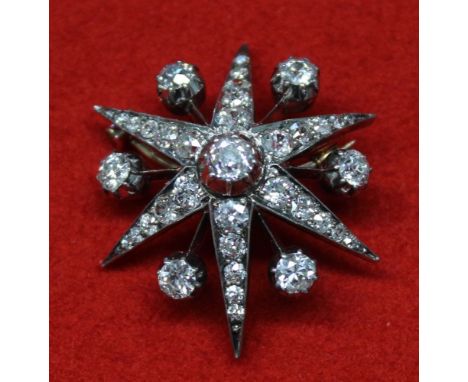 A Victorian diamond brooch, six pointed star shape, silver and gold frame, having a central round old cut diamond, approx.55c