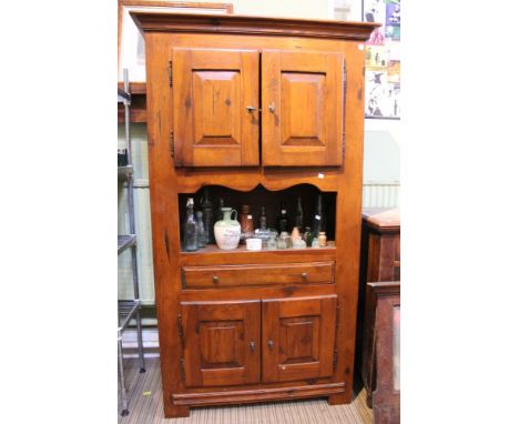 A substantial larder cupboard with two sets of double doored shelf units single drawer and open shelf