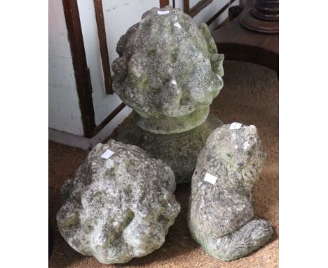 A cast garden finial together with another and a seated cat