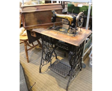 A manual Singer sewing machine with treadle table