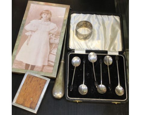 Two hallmarked silver photograph frames, a case containing five silver coffee bean spoons, silver handled button hook and a w