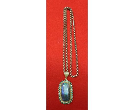 An Opal, set in a gold coloured frame mount, inset cut green stones, suspended from a 9ct gold chain, gross weight 15g&nbsp;