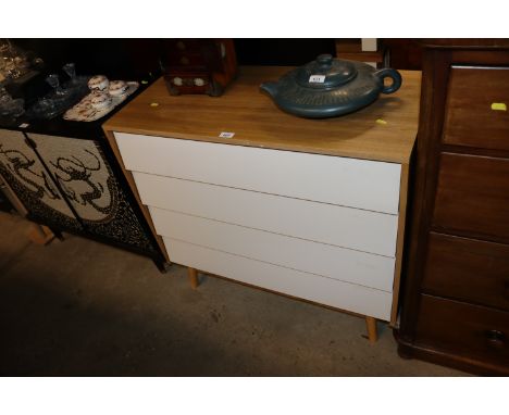 A modern light wood chest fitted four long drawers 