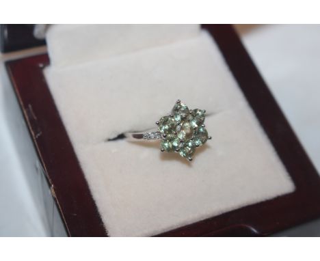 A 9ct white gold ring set with cluster of Amblygonite and Zircon set shoulders, ring size L/M, approx.2.5gms total weight