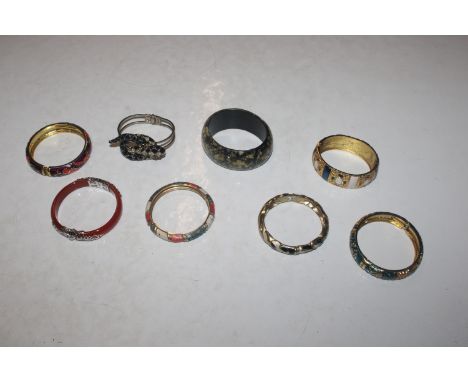 A carnelian and white metal bangle and other enamel decorated bangles 