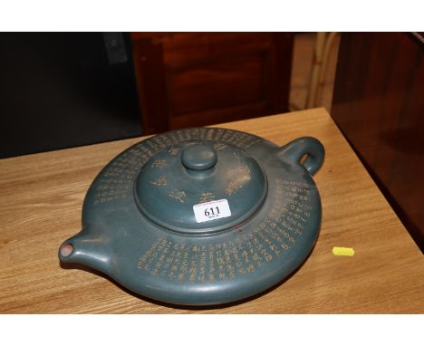 A large Chinese green glazed terracotta teapot of squat form having all over decoration of calligraphy, seal mark to base, ap