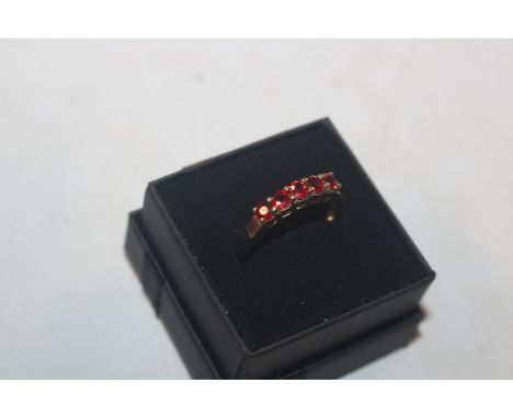A 9ct gold ring set with five ruby coloured stones, ring size N, approx. 2.5gms total weight