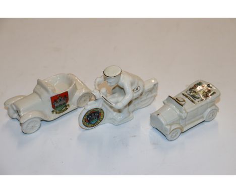 Two crested china ornaments in the form of vintage motor cars and another in the form of a dispatch rider 