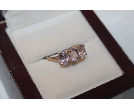 A 9ct gold ring set with three Kunzite stones, ring size L/M, approx. 1.8gms total weight