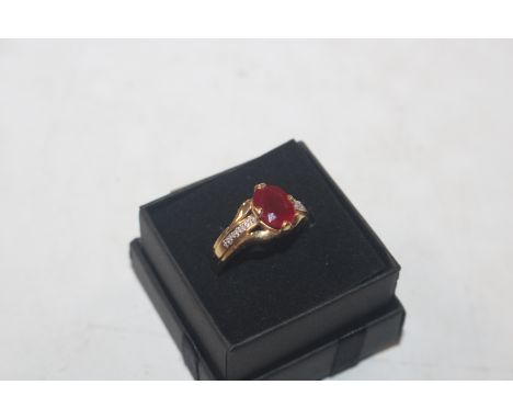 A 18ct gold ring set with ruby coloured stone and chip diamond set shoulders, ring size N, approx. 5.2gms total weight
