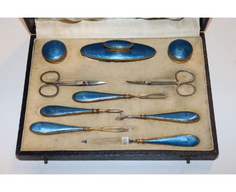 A boxed blue guilloche enamel decorated manicure set 