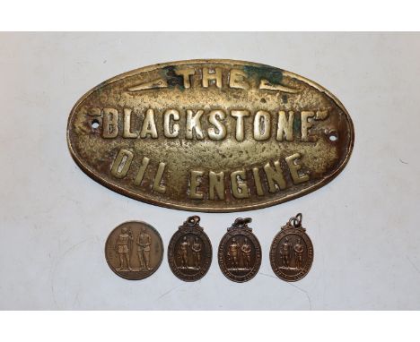 A brass sign "The Black Stone Engine Oil" and four Rifle Club sporting medallions 