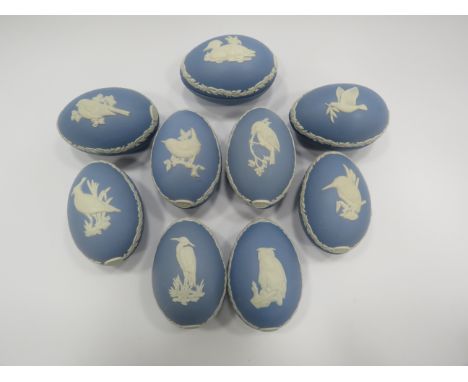 9 Wedgwood Jasperware light blue christmas eggs decorated with various birds.