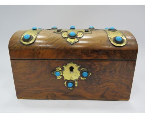 Vintage tea caddy in the style of a treasure chest decored with brass and turquoise stones.