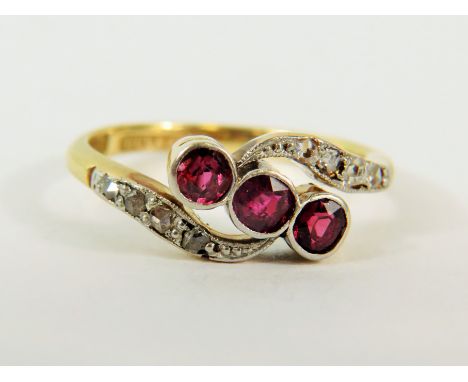 18ct Yellow Gold Ring set with Three Rubies with Diamond set waves to top and bottom.   Finger size 'M'  3.3g