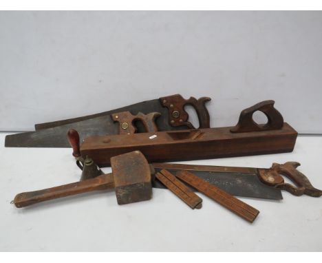 Selection of vintage tools including Jointing plane body, wooden mallet, Saws and wooden rulers.