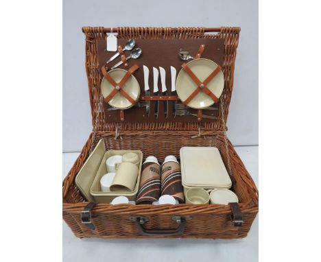 Vintage picnic basket with Brexton accessories.