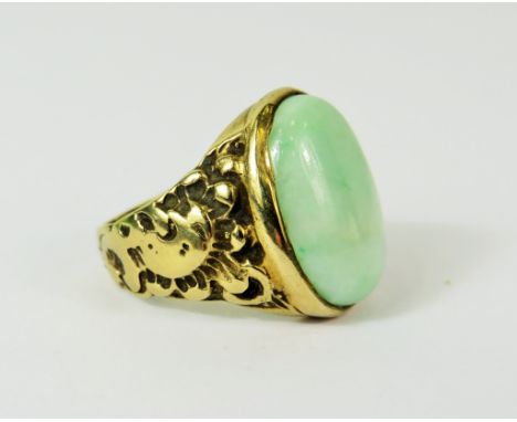 Large Oval Jade ring set in a heavy 9ct Mount with scrolled shoulders.   Finger size 'Q'   Total weight 10.9