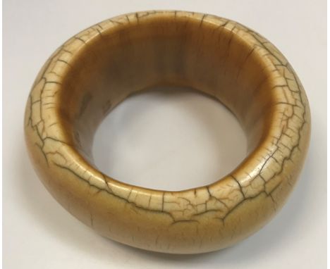 A 19th Century African ivory bangle of heavy proportions, 9.5 cm x 8.5 cm, 237.2 g, 7.63 oz 