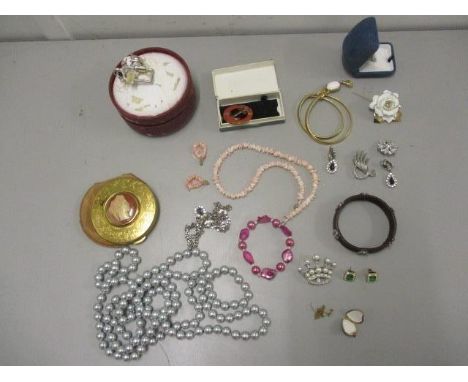 Costume jewellery to include a pair of Christian Dior earrings, a 9ct gold locket and chain, coral jewellery, brooches, a com