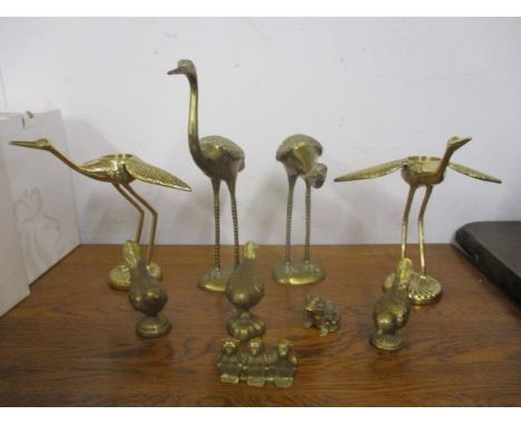 Brass model birds and animals to include a pair of cranes, a pair of bird tea light holders, a frog and similar items 