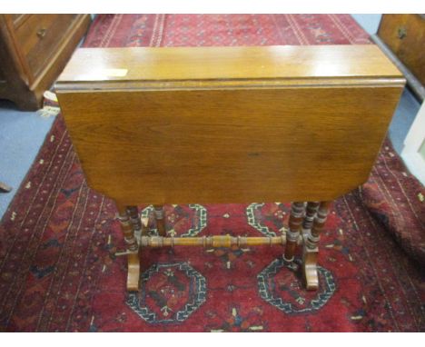 A late Victorian walnut Sutherland table on ring turned legs 