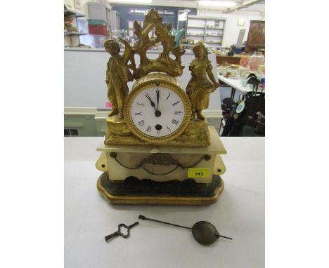 A 19th century French gilt metal and alabaster cased mantel clock on a gilt wood and fabric stand A/F (with pendulum and key)