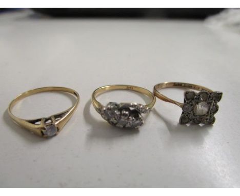 An 18ct yellow gold and three white stone set ring, a yellow metal and white stone solitaire ring and a 9ct white stone synth