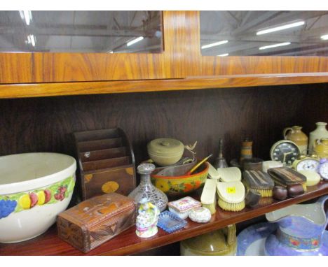 A vintage collection of alarm clocks, pipes, ivory dressing table brushes, treen, ornamentals, an inlaid letter rack and a gl