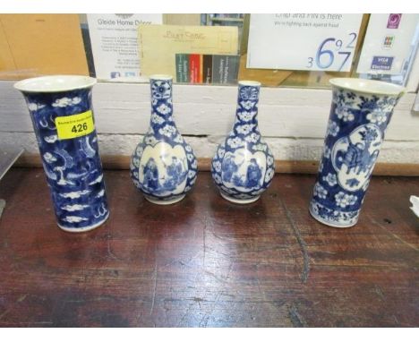 A pair of late blue and white pear shaped vases, each with two reserves of Chinese figures in landscapes, four character Kang