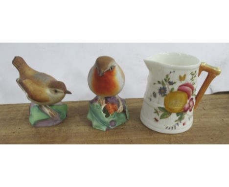 Two Royal Worcester birds, together with a Royal Worcester barrel moulded jug