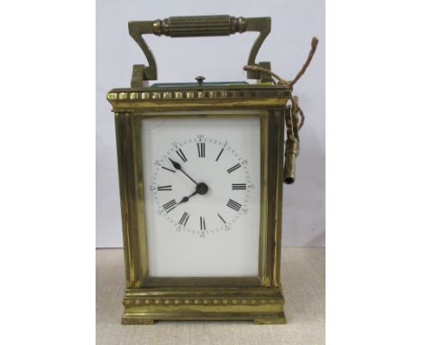 A brass cased repeating carriage clock, with enamel dial and Roman numerals