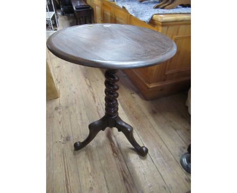 A circular 19th century occasional table raised on a tripod base with turned column legs 20ins x 27ins&nbsp;
