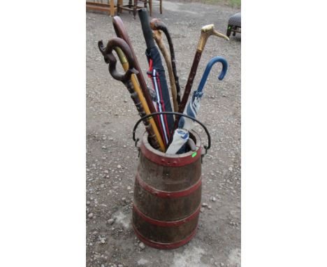 A coppered barrel stick stand, with metal swing handle, together with walking sticks etc