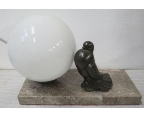 An Art Deco style table lamp, with glass ball and metal fan tail dove, on marble base