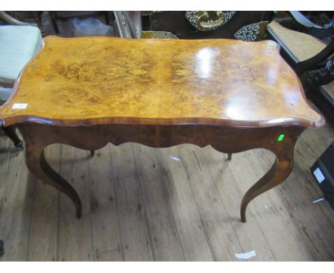 A 19th century burr walnut serpentine shaped fold over card table, with quarter veneered cross banded top raised on cabriole 