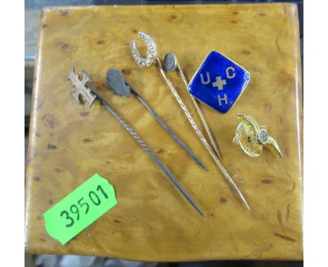 A 14k and enamel badge, weight 2.7g, together with stick pins and an RAF brooch, in a wooden box