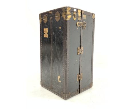 Early 20th century upright travelling trunk, interior fitted with drawers and hanging provision, bearing various travel label