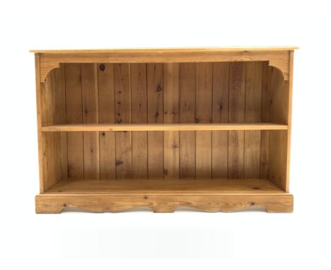 20th century pine bookcase with one fixed shelf, raised on shaped plinth, W123cm, H77cm, D28cm Condition Report & Further Det