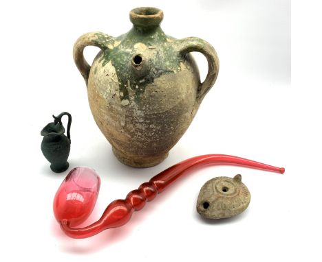 Three antiquities comprising a stoneware flask, small lamp and a small metal jug and a Nailsea style glass pipe Condition Rep