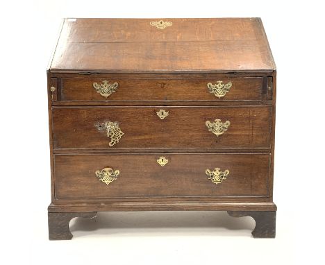 19th century oak bureau, the cross banded fall front revealing interior fitted with drawers and cubby holes, over three long 