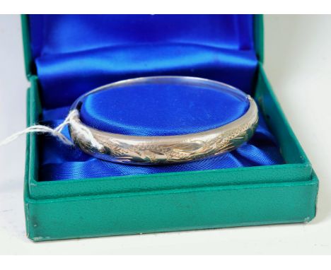 A boxed Excalibur sterling silver hinged bangle, with engraved decoration