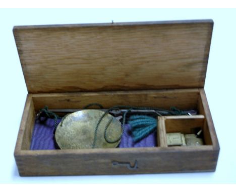 A Victorian oak cased set of brass pawnbroker's scales