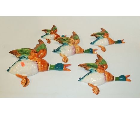 A graduated set of five Beswick flying duck wall ornaments, the largest impressed Beswick England 5960, w.28cm   Condition Re