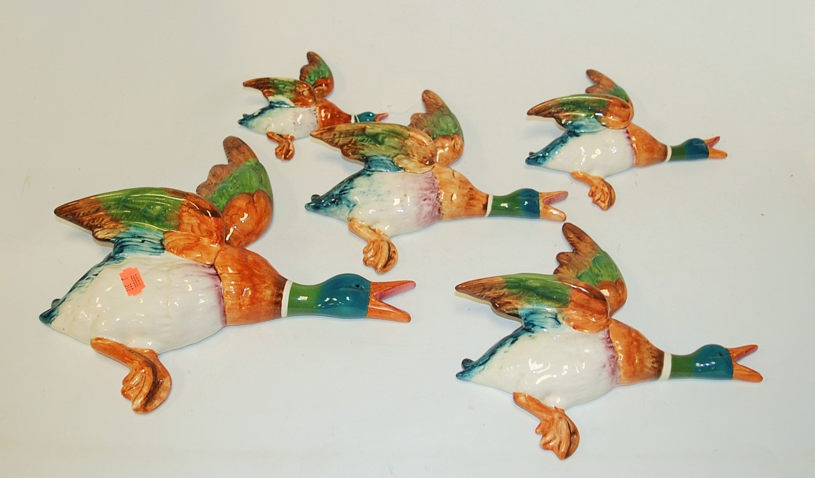 A graduated set of five Beswick flying duck wall ornaments, the largest